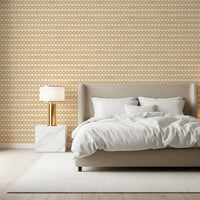 Warm ochre and off-white give the Zellige Cross Sand wallpaper its calm palette.