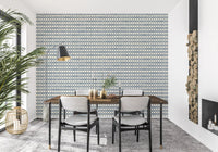 Repeating cross motifs on slate blue wallpaper warming a relaxed dining room