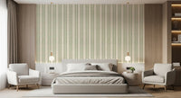 Vertical sage green ornament stripes on a cream linen-textured zellige wallpaper.