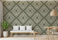 A muted palm green ornament wallpaper frames this open dining room