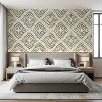 Concentric diamond medallions warm a restful bedroom in this palm green wallpaper