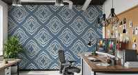 Ivory beadwork spreads outward in even rings on this slate blue ornament wallpaper