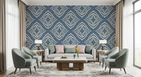 A bold slate blue ornament wallpaper keeps this living room grounded and calm