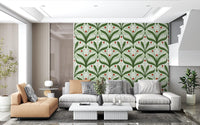 Mirrored green leaves and white lily bells fill this ladybug wallpaper