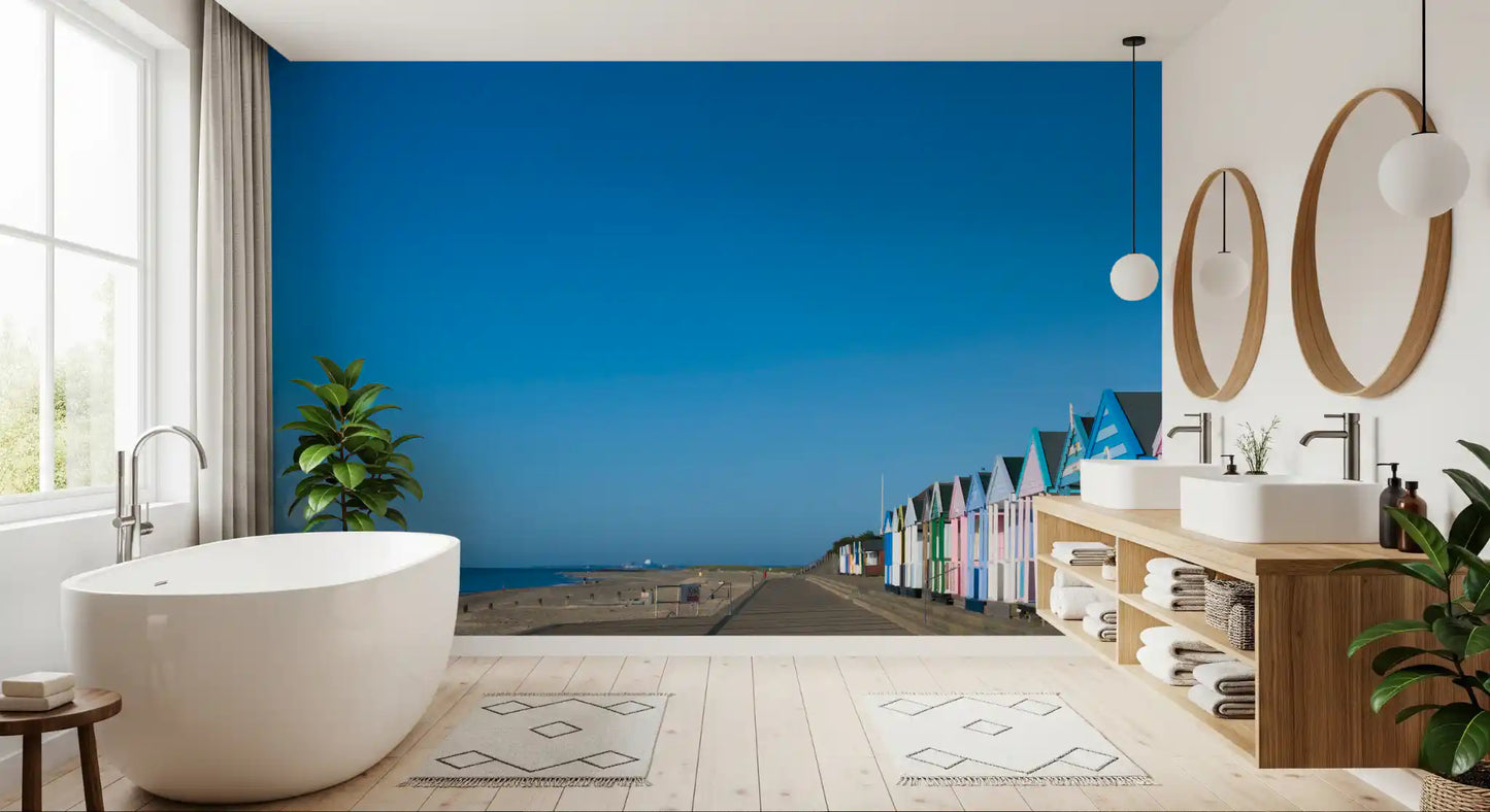 Blue sky and pastel fronts brighten a Bathroom via the Beach Hut wall mural
