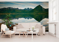 A calm blue sky meets green ridges in the Emerald Peaks Mirror Waters wall mural.