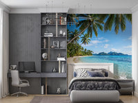 Leaning palm trunks arch over a curved shoreline in the Beachside Serenity wall mural