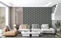Tribal triangle repeats give a Living room a calm, gallery-style charcoal wallpaper feel
