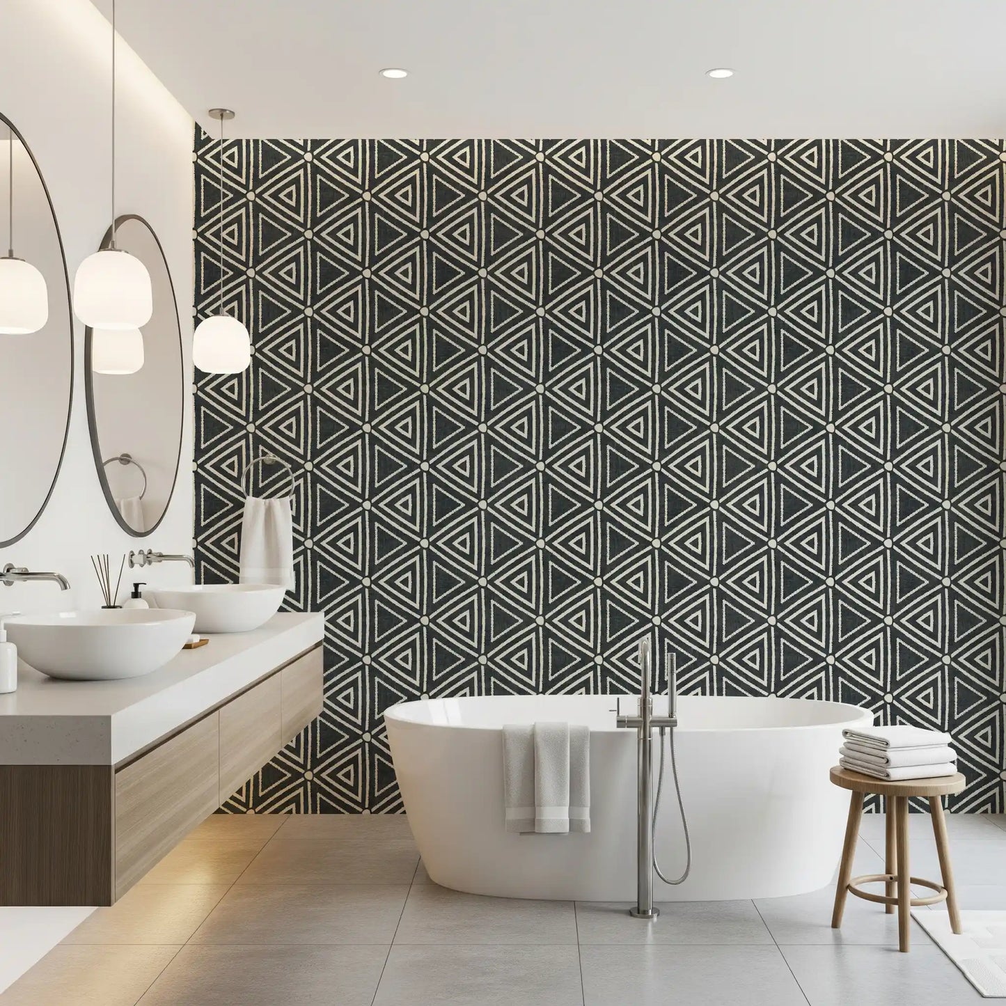 Irregular triangle outlines lend the charcoal mudcloth wallpaper a woven, tribal look