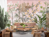 Green stems, yellow florals and two birds rise from a blush base in this wall mural