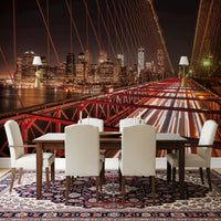 A Brooklyn wall mural creates a dramatic backdrop inside a modern Dining space.