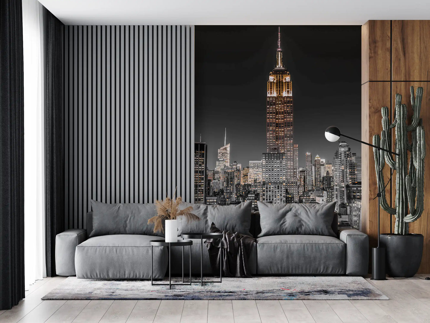 A grey living room sofa faces outward from the illuminated skyscraper NYC wall mural.