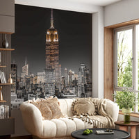 The Empire Glow NYC Night in Grayscale Gold wall mural shows a tall skyscraper