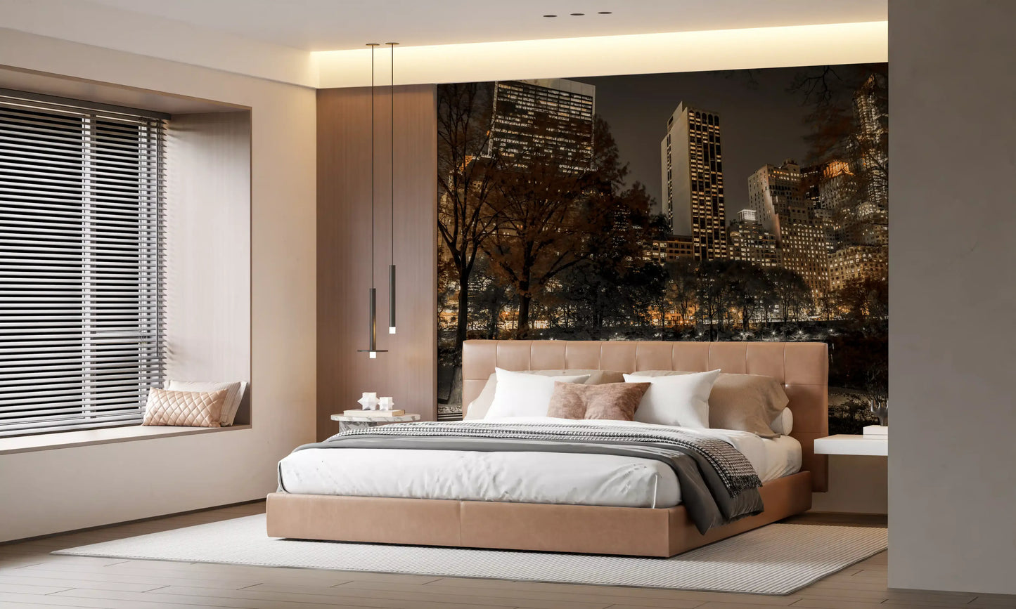 Towering skyscrapers glow over autumn treetops in the Urban Oasis Nights wall mural