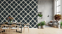 A bright dining room showcases dark contrast through this geometric trellis wallpaper.