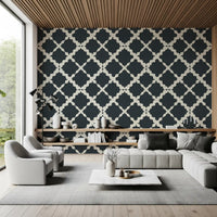 Minimalist modern wallpaper introduces repeating wavy lines into a sunlit lounge area.