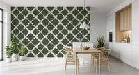 A dining room features classic green lattice wallpaper style.