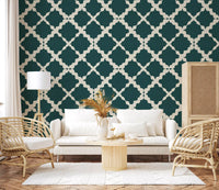 Repeating quatrefoil shapes laid in cream over teal trellis wallpaper background