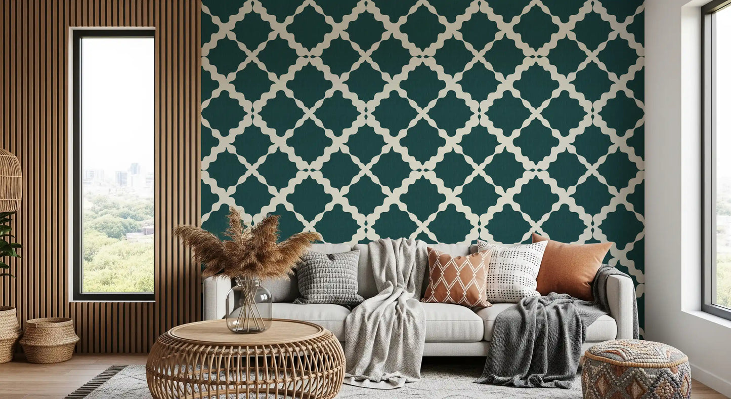 Deep teal wallpaper holds an ivory trellis grid built from minimalist quatrefoil tiles