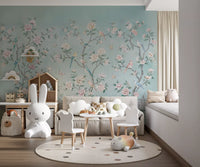 The Chinoiserie Aviary wall mural surrounds a kids' room with peony stems and birds.