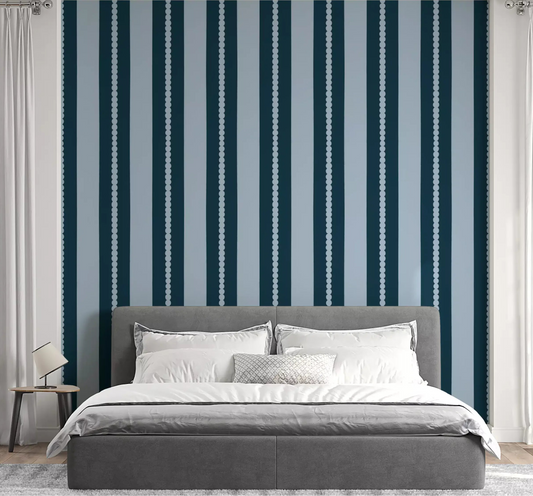 A navy striped Scallop & Dot Vertical Harmony Wallpaper⁠ lines the bedroom.
