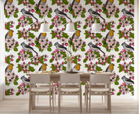 Pink petals with robin and titmouse liven a dining room in Birds and Blossoms wallpaper.