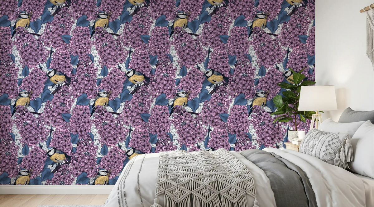 Birds in violet lilac garden wallpaper creates a serene mood in the bedroom.