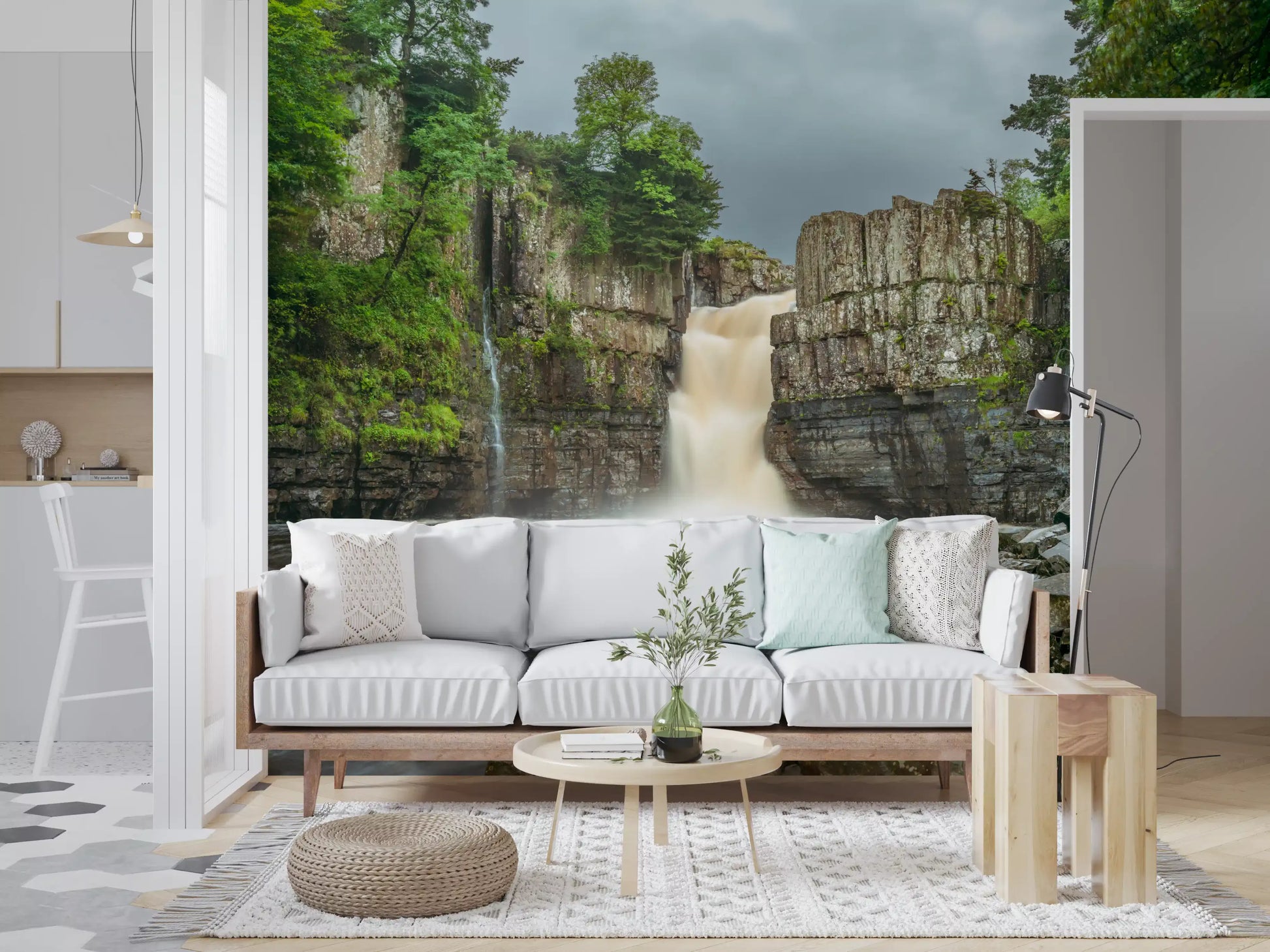 Greenery from a Falls wall mural surrounds a lounge space.