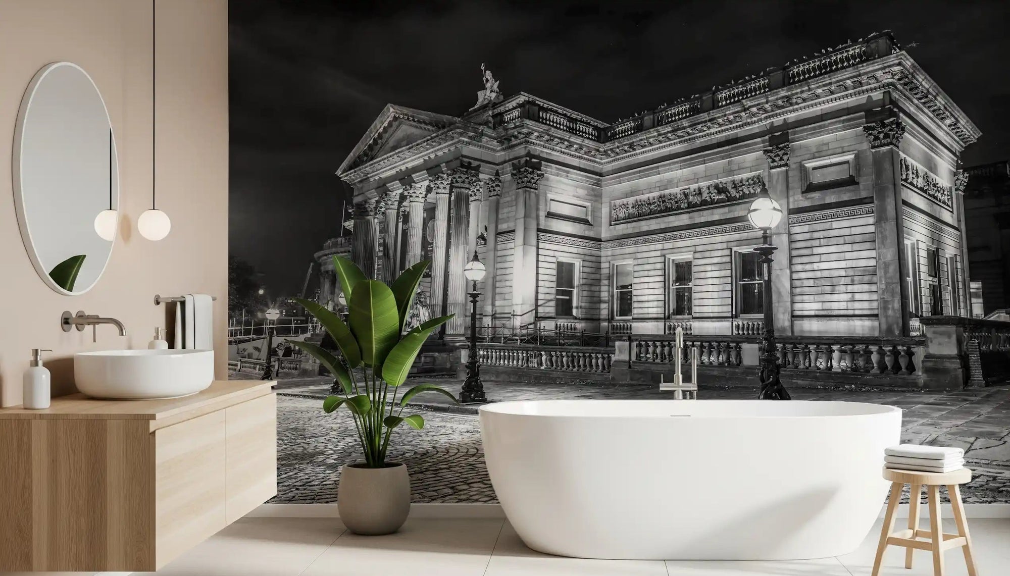 A sleek freestanding tub sits near the Classical Nightscape wall mural in this bathroom.