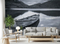 Grey ridges and lake water keep the Living room restful behind a Silent Waters wall mural.