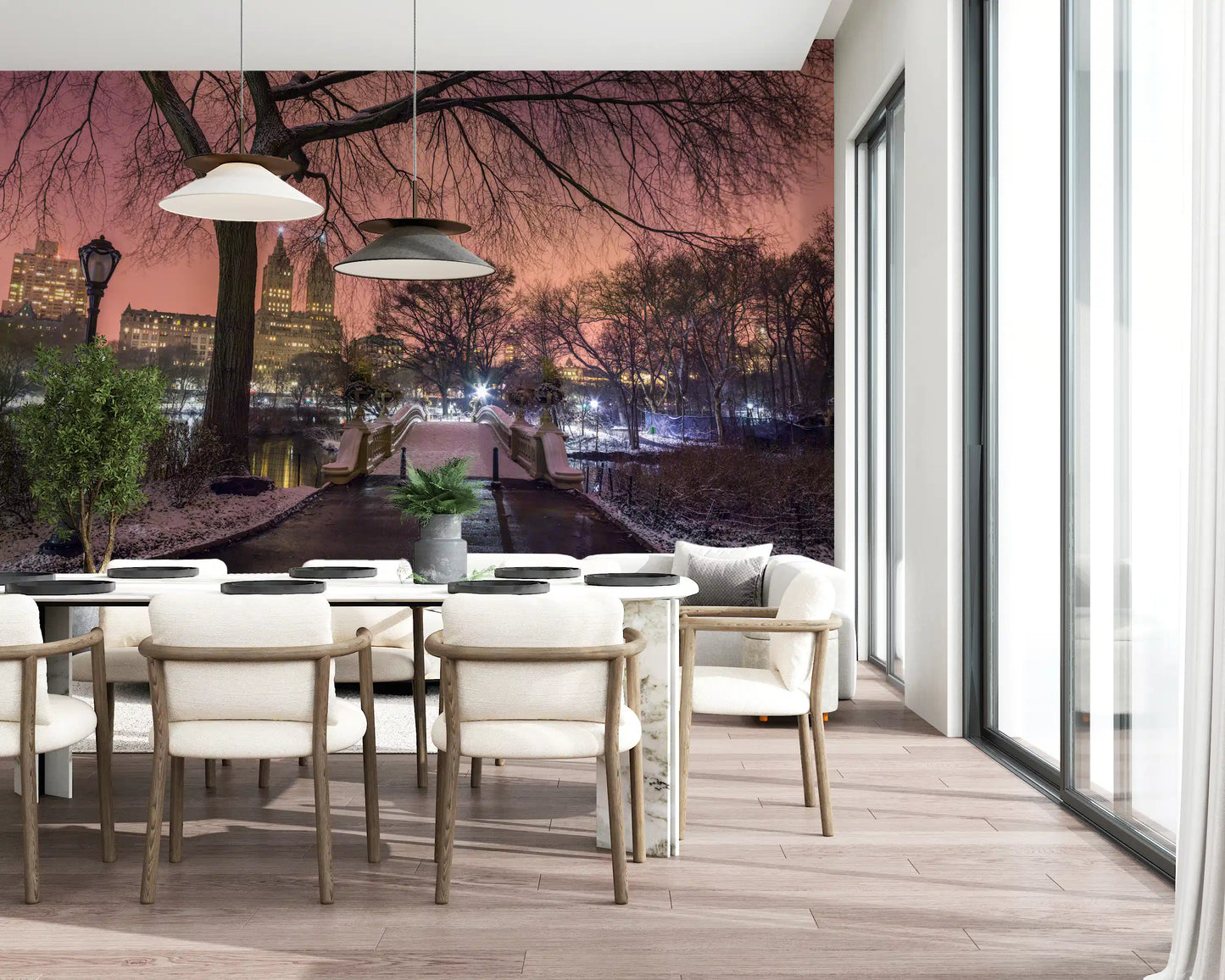 Bare branches frame a pink dusk dining room view inside this Central Park wall mural.