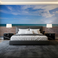 Sea, sky, and pebble shore span the Horizon wall mural view