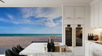 Cool teal water and warm sand tones meet in the Blue Horizon wall mural palette