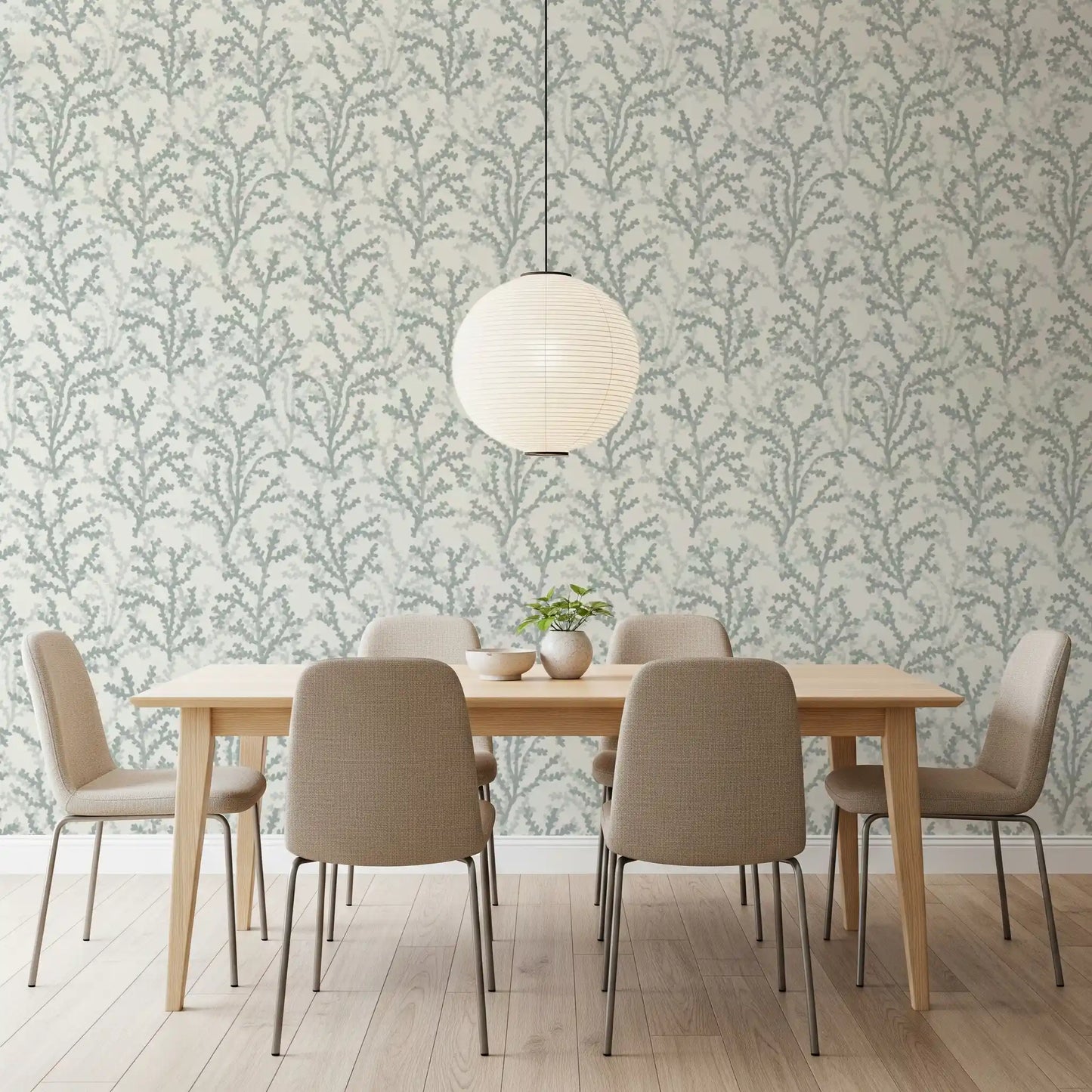 A leafy branch pattern wraps the dining room area in Painted Coraline wallpaper tones.