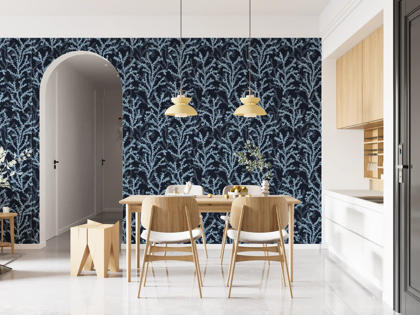 Flowing over the kitchen space are azure branches on the dark wallpaper