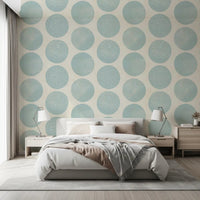 Blue and beige wallpaper showing speckled circles in an open repeat
