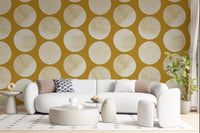 Cream on mustard wallpaper showing large textured polka dot forms