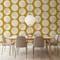 Dining room with cream mustard wallpaper and oversized stippled circles