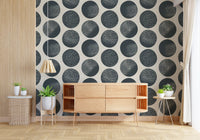 Cream wallpaper showing dark blue dotted forms in a clean repeat