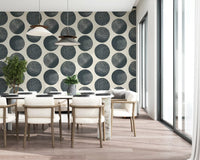 Dining room featuring stippled dot wallpaper in dark blue and cream tones