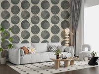 Living room with slate grey polka dot wallpaper on a soft cream background