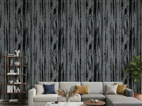 Living room with charcoal grey woodgrain wallpaper and abstract vertical grain lines