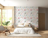 Cream backdrop holds the storybook motifs of the Baby Village wallpaper neatly