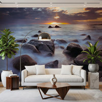Low sun glows above a silky sea on this Lofoten wall mural