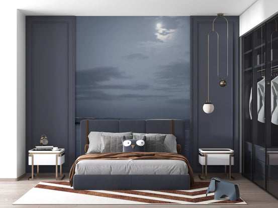 Moonlit Ocean Serenity wall mural set behind a bed in a deep blue bedroom