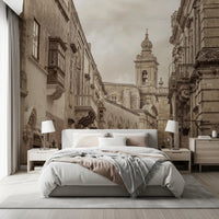 Bedroom scene led by the Mdina wall mural and its baroque spire