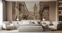 Bedroom setting holds an old-town street wall mural in muted browns
