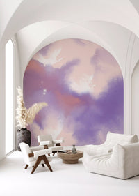 Cranes drift across this living room wall mural in pink and lavender cloud