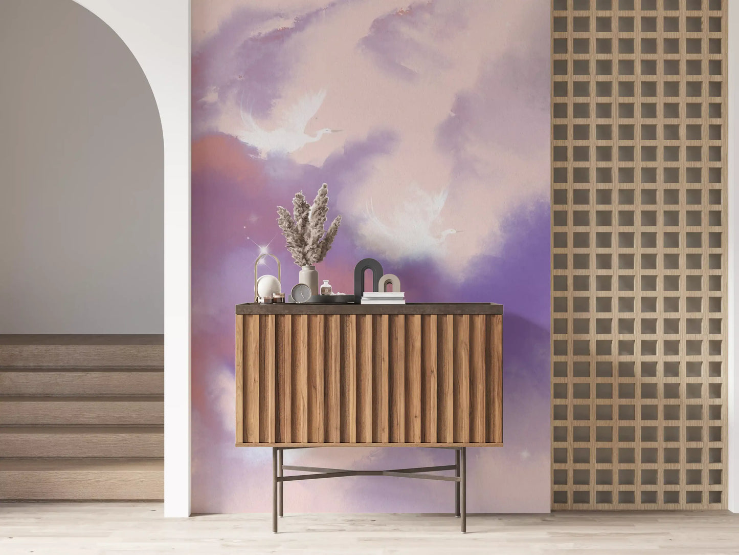 Pink and lavender cloud washes spread through a lounge with this wall mural