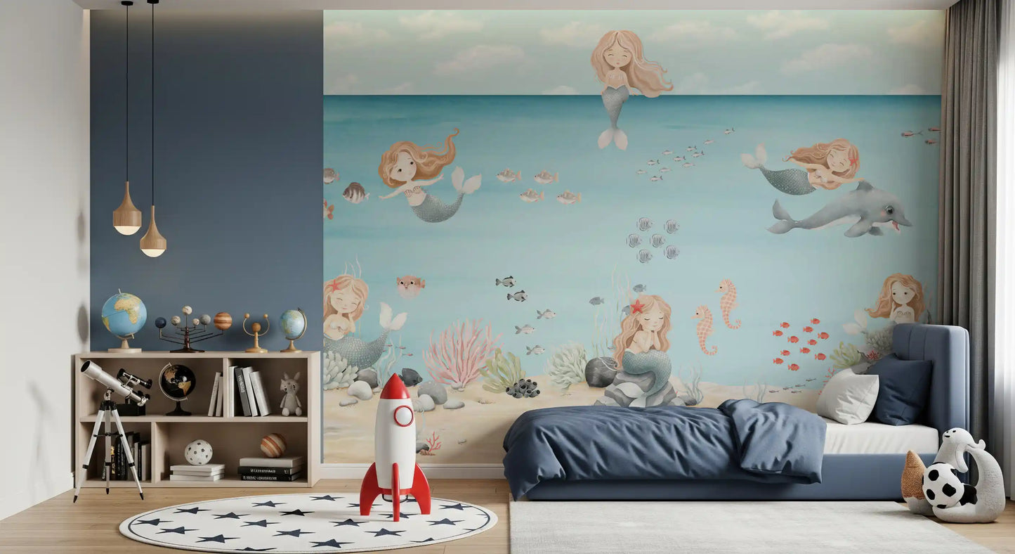 Boys Bedroom cot sits below mermaids and a dolphin on the Lagoon Dreams wall mural